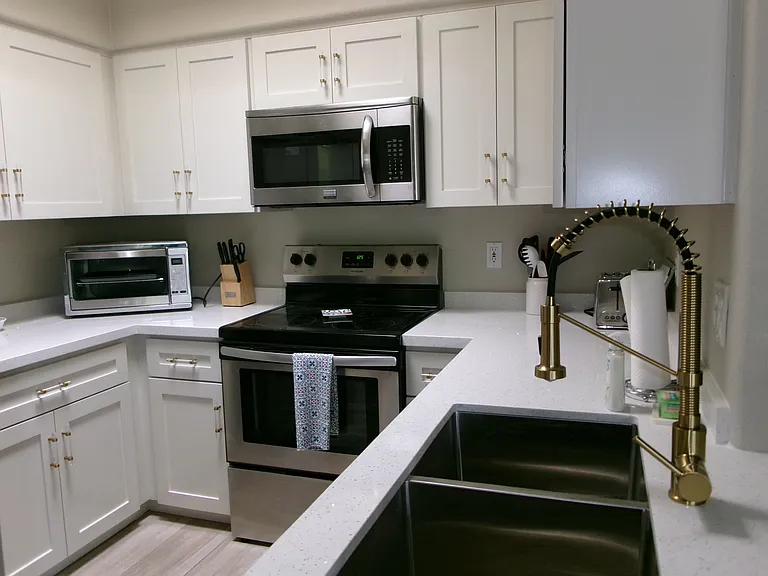 New cabinets, new quartz counters, new faucet, new sink.