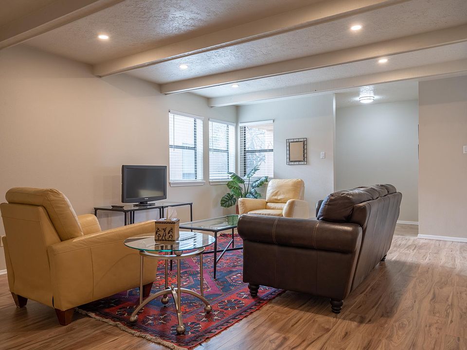 comfortable, spacious living room with plenty of natural and overhead light