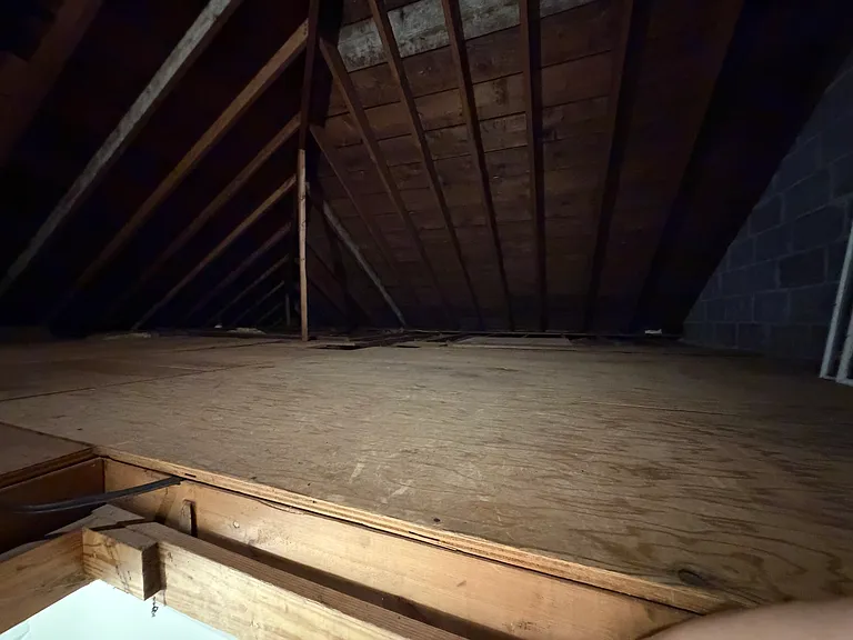 Plywood covers most of attic space, allowing plentiful storage of decorations, crafts, seasonal clothing, etc.