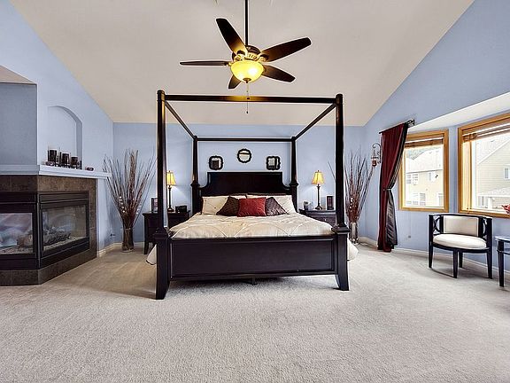 Master suite with vaulted ceiling and gas fireplace.