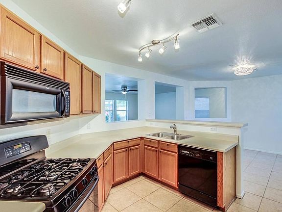 Double sink, dishwasher, over the range microwave and gas stove/oven.