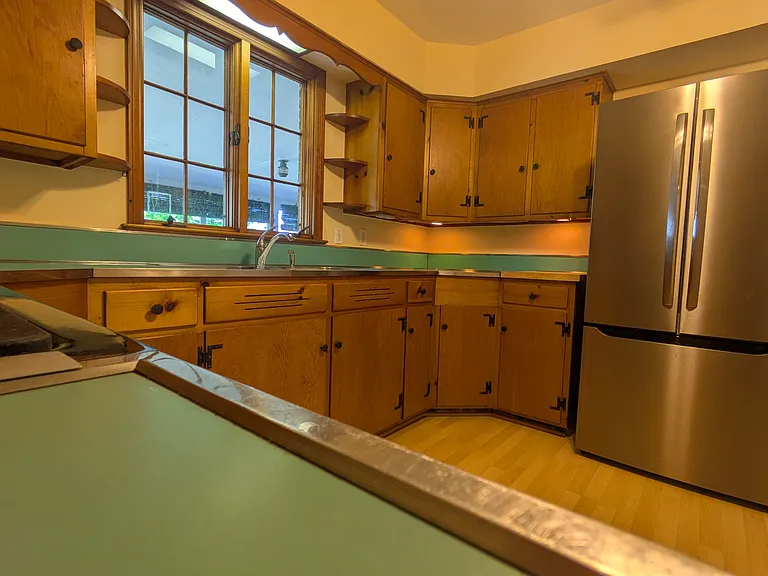 Original 1950s cabinets, countertops and stainless rims. New appliances and floor.