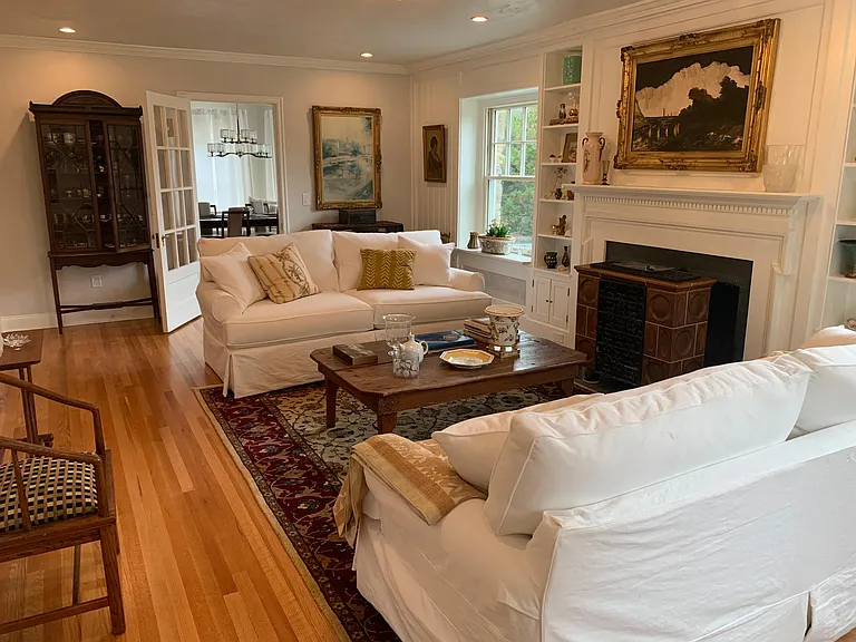 Living room with fireplace and built in shelving & book case surrounding fire Mattel.