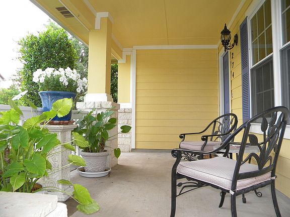 Covered Front Porch Overlooks Beautiful Yard
