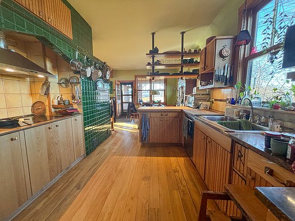 Kitchen island and shelves , other side dining area