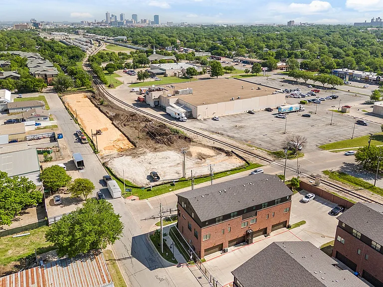 Exterior, aerial view of two-car garage and gated parking lot and street. Additional tenant parking on the right.