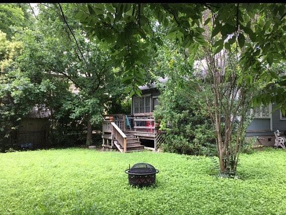 It has a large, shared, fenced yard with a back porch