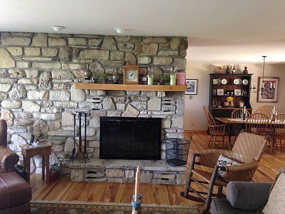 Great living space : Living room with gorgeous stone fireplace flows nicely into the dining room.