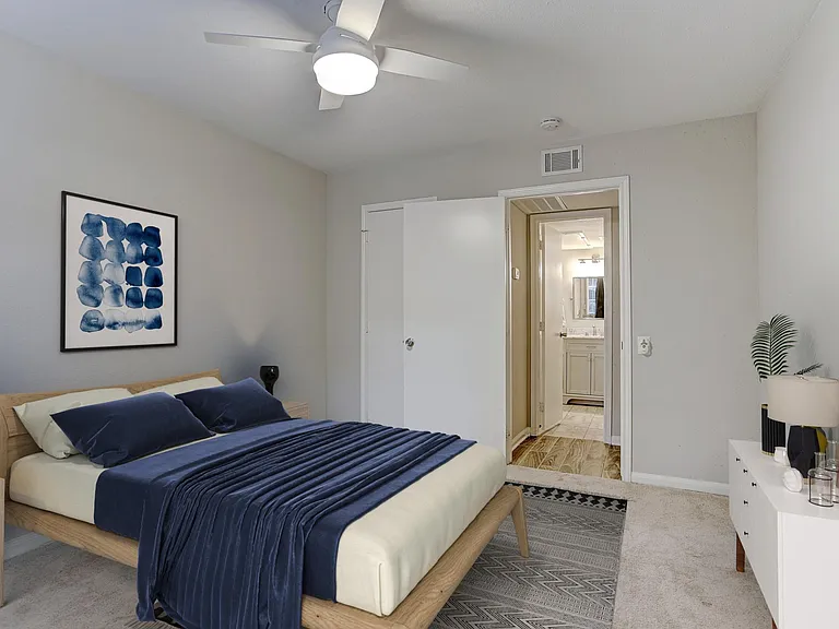 Large bedroom with brand new remote-control fan and walk-in closet.