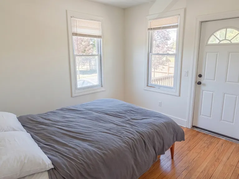 Back bedroom w door opening to back porch.