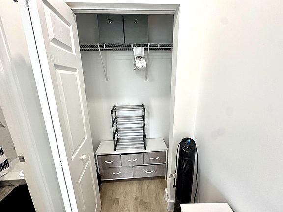 Large closet with shelving and drawers