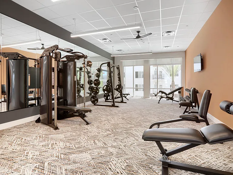 Serious about your fitness. The Garrett Uptown weight room is outfitted with a functional trainer, squat rack, adjustable benches, and full mirror coverage.