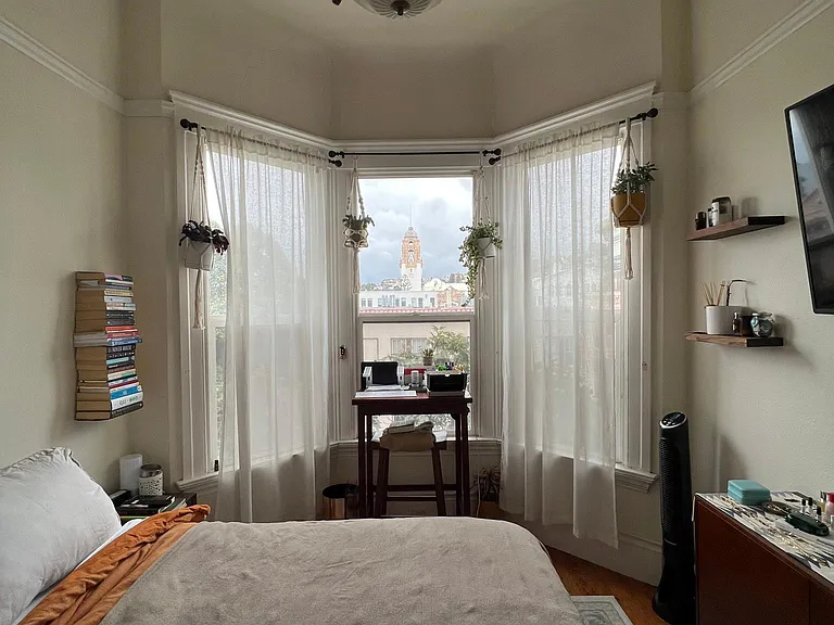 A bay window room used as bedroom.