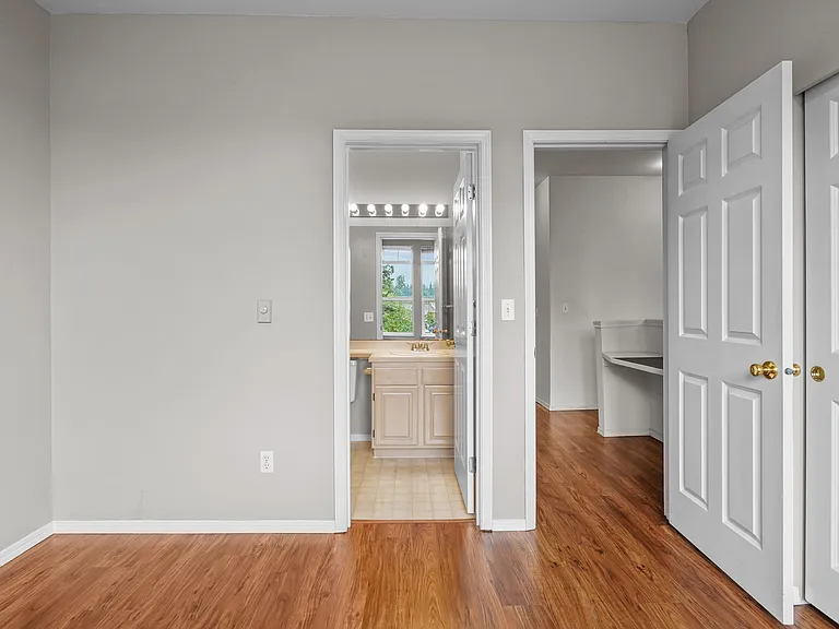 Guest bedroom showing bathroom entry and room entry door.
