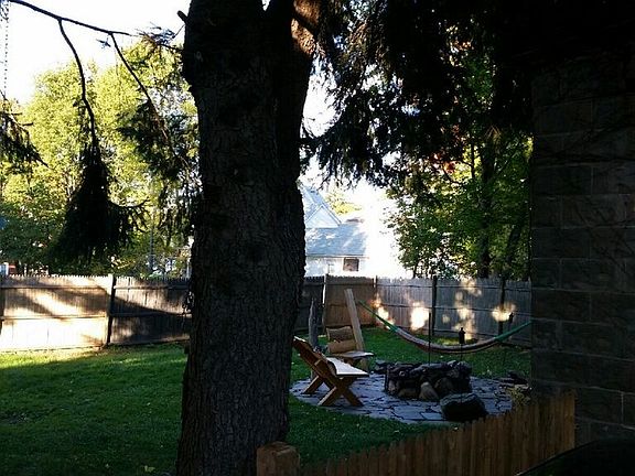 Fenced back yard with fire pit