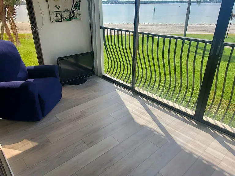 Florida room with TV and sliding doors to the private beach