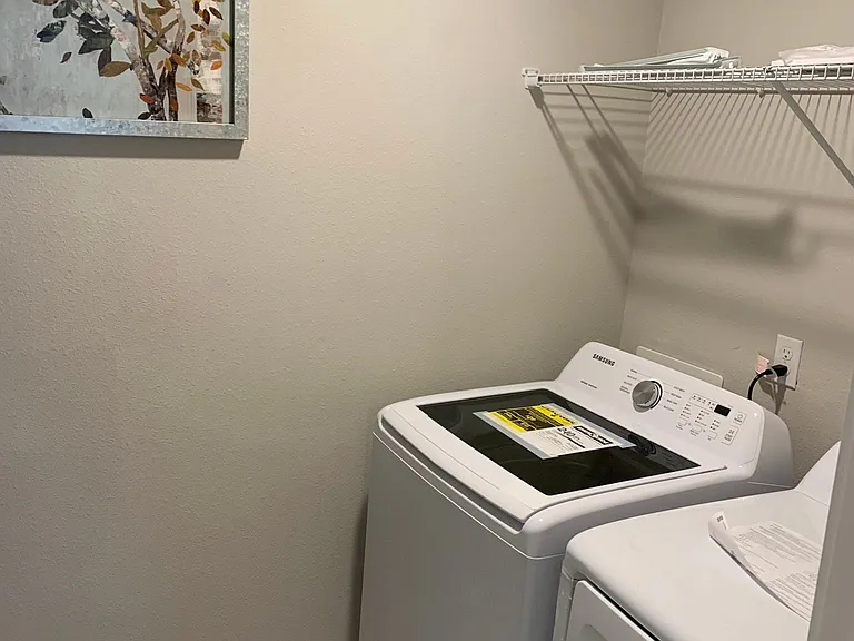 Laundry room with brand new king size washer/dryer units