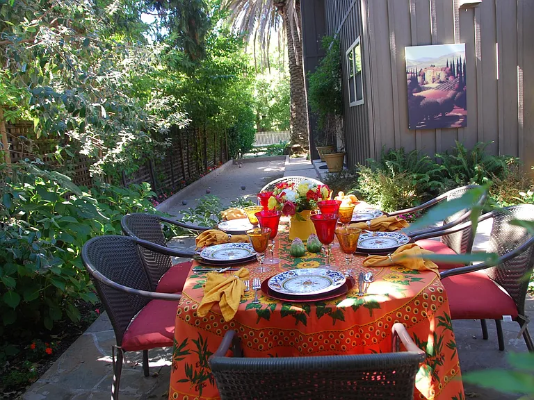 Dining area with Boccie Court along the side of the house