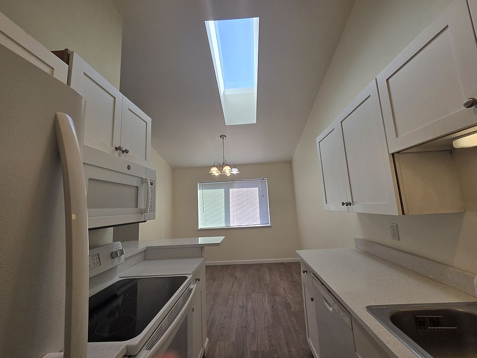 Kitchen with Skylight - Living Room, Kitchen, and Dining Room are Luxury Vinyl Plank (LVP) Flooring