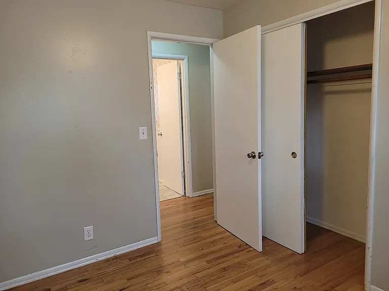 Bedroom #4 in front of house real hardwood floors, a ceiling fan and is across from the hallway bathroom. A nice office space.