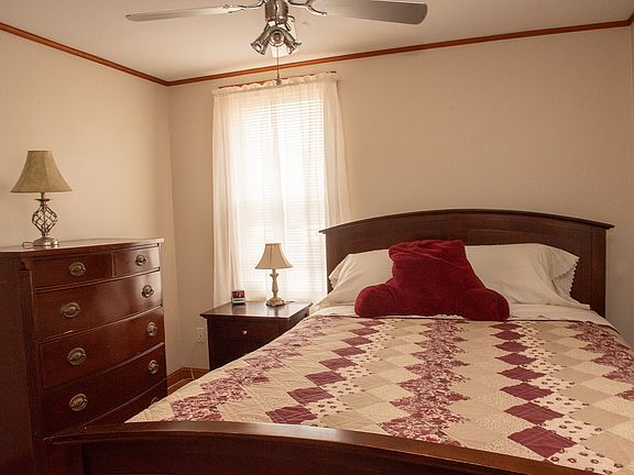 Bedroom off of living room. Large antique bureau and night stand. Room has 2 windows, and large closet.