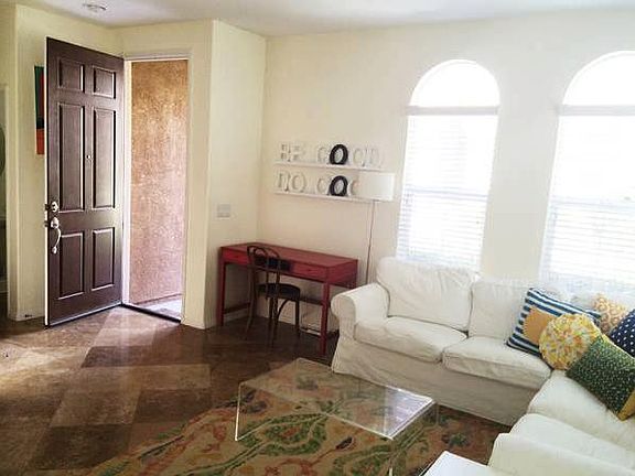 Spacious living room with media nook and many windows