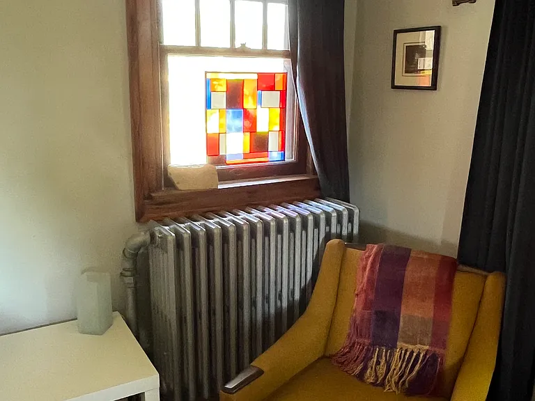 Stained glass and a chair to relax and read