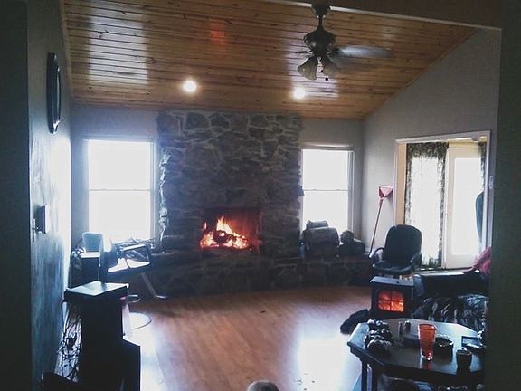 Living room. New hardwood floor and wood burning fireplace.