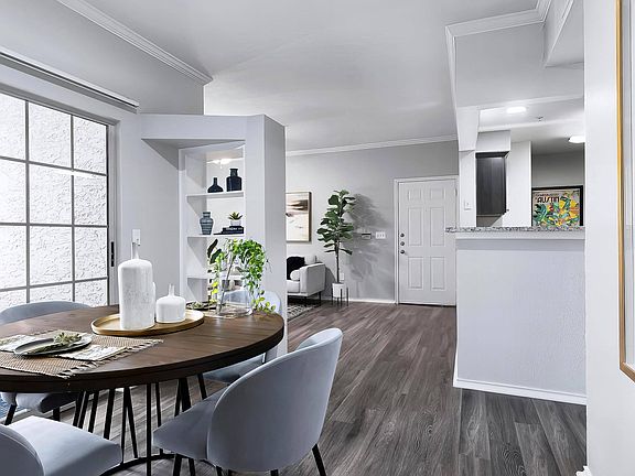 Open Floorplan with Dining Area, Built-In Shelves, and Sliding Glass Door to Patio