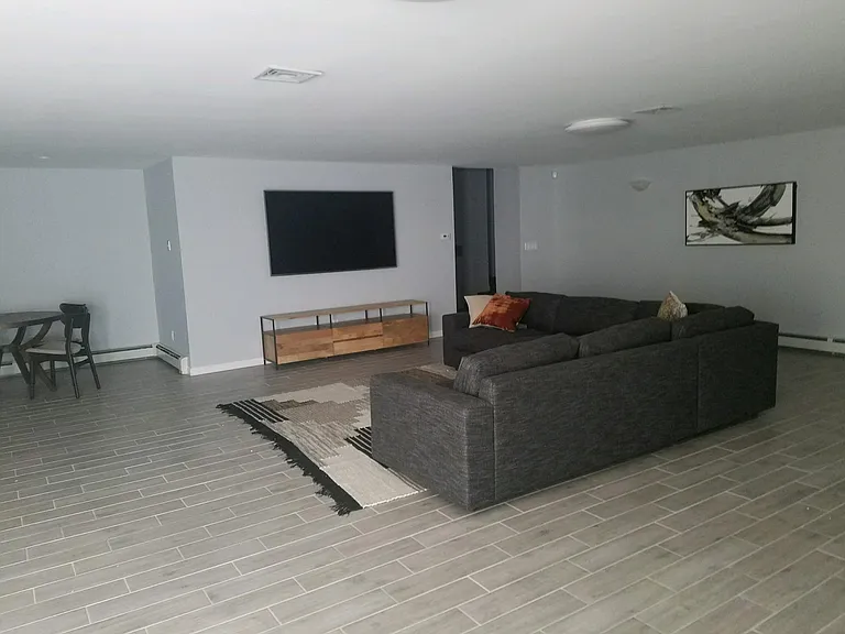 living room with walkout to stamped concrete patio and. below ground pool