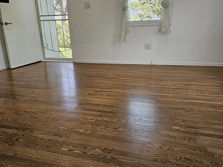 Front room, highlighting real hardwood floor.