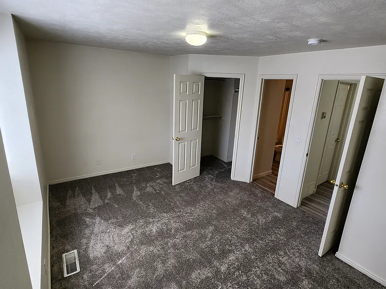 Master bedroom, showing closet, 2nd entrance into bathroom, and doorway out to landing