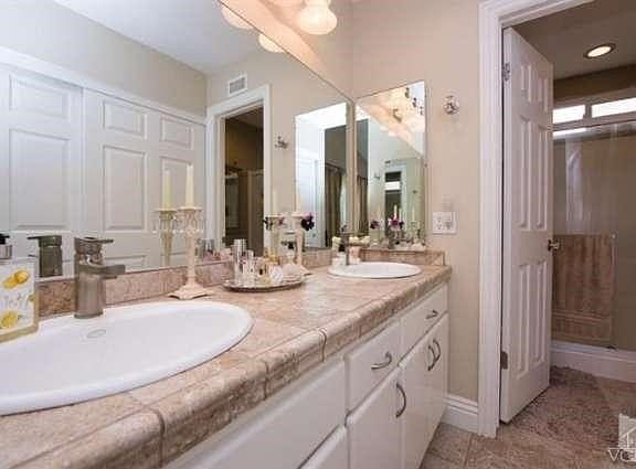 Master Bathroom with two sink vanity and additional closet