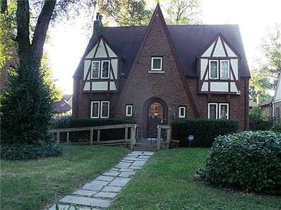Front of home with stained glass windows in LR/DR.