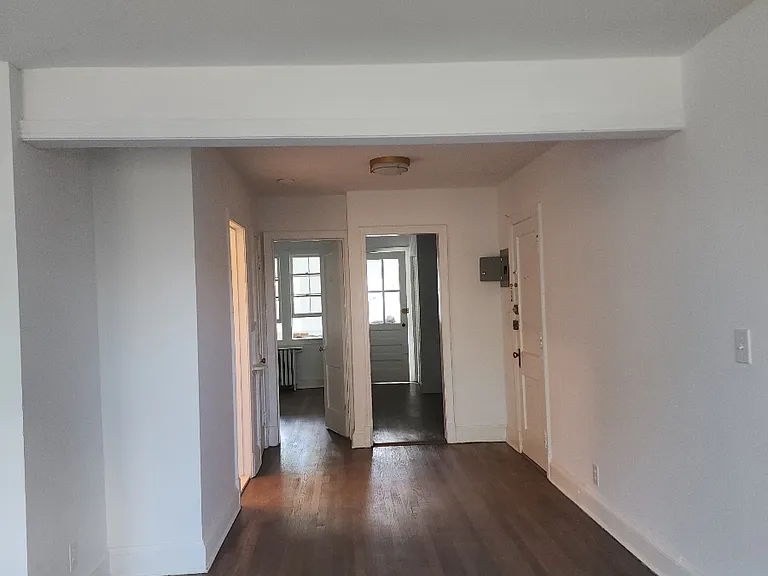 view from living room to kitchen, bathroom, bathroom and front door