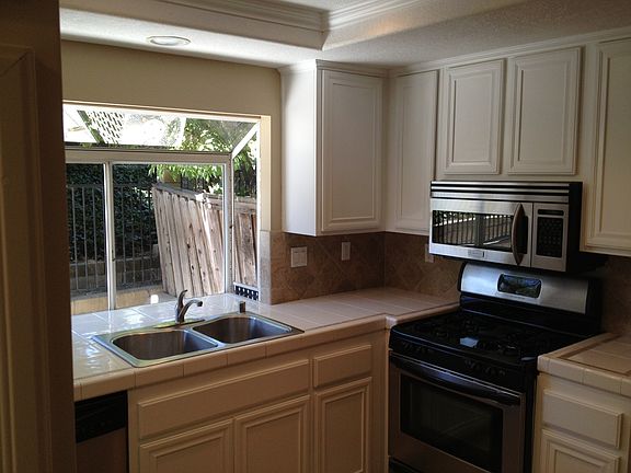 Upgraded stainless steel appliances with plenty of cabinet space in Kitchen