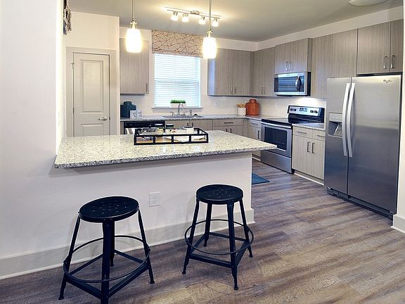 Stunning kitchens include granite countertops and stainless steel appliances