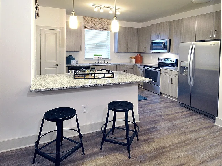 Stunning kitchens include granite countertops and stainless steel appliances