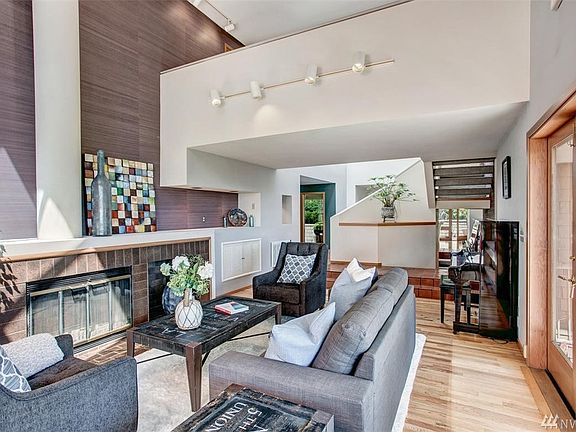 French doors to the left lead out to the wrap around deck and sitting area that is partially covered.
