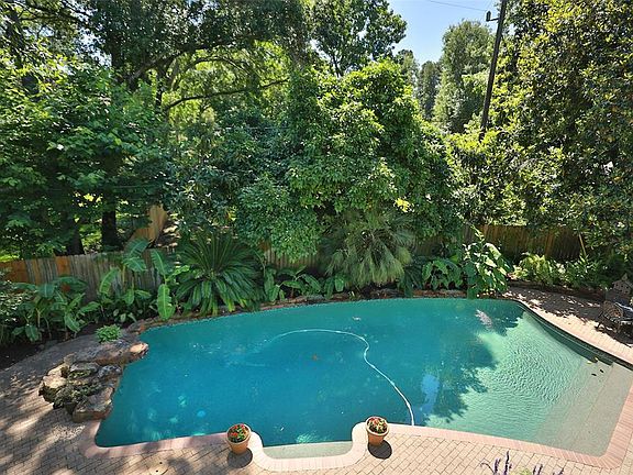 BACKYARD - Back yard has beautiful 24,000 gallon pool with Pebble Tec finish, diving rock, and spraying water feature. Lush landscaping provides lots of privacy.