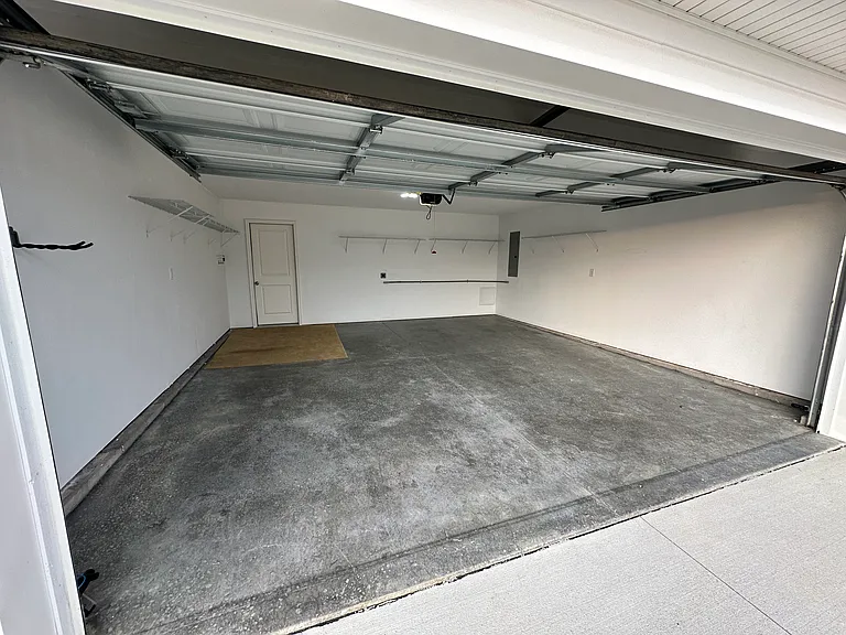 2 car garage with wall shelving