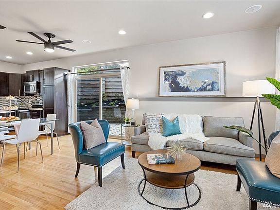 Large windows and sliding glass doors in the living room and kitchen provide lots of natural light.