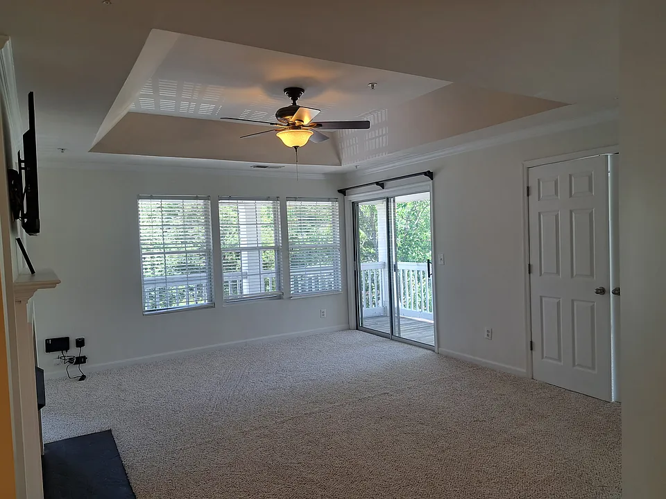 Living from another angle, showing the balcony through the sliding door. Check out the high ceiling giving it a majestic sense. You have to see it to believe how great it looks.