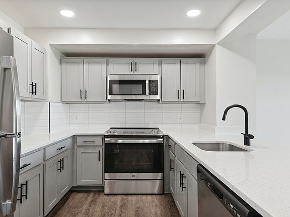 Select homes feature upgraded kitchens with quartz countertops and wood flooring