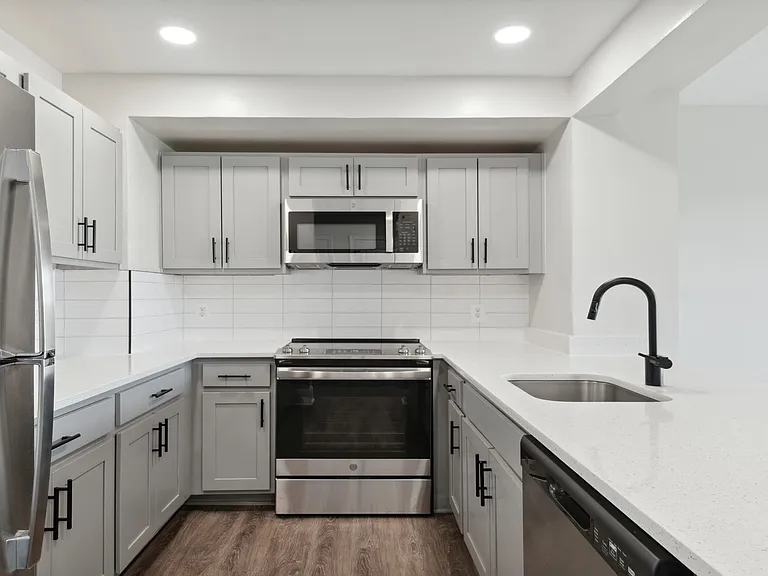 Select homes feature upgraded kitchens with quartz countertops and wood flooring