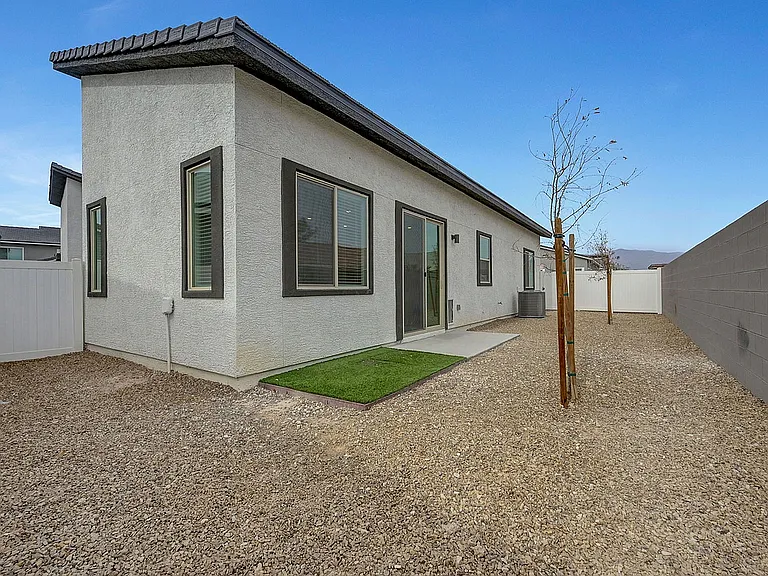 Explore the elegance of modern design with this spacious backyard view.