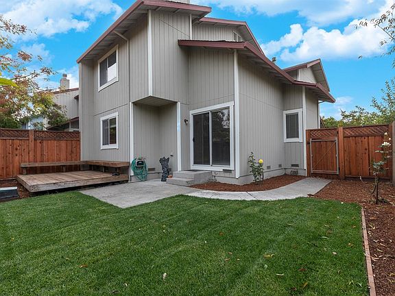 Spacious rear yard and deck with benches.