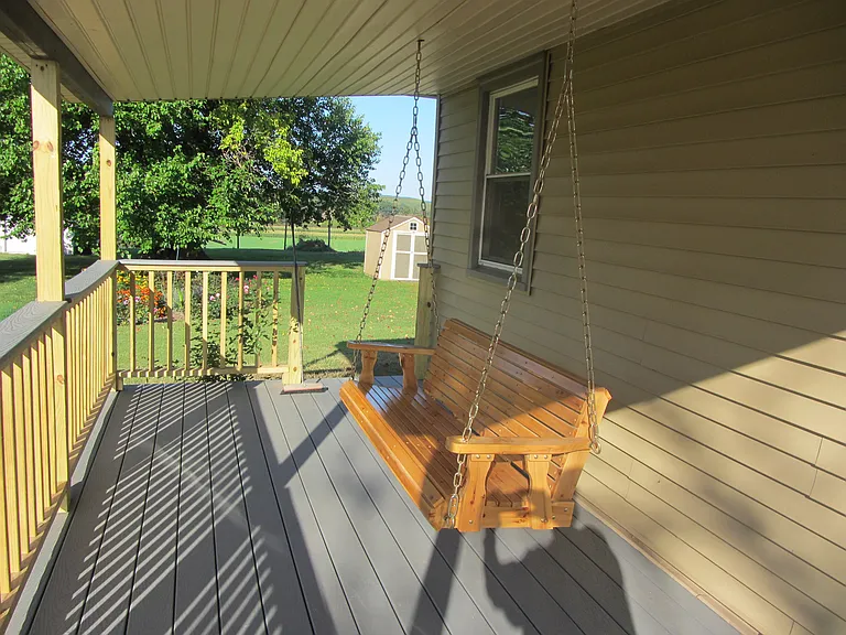 Covered porch with swing.