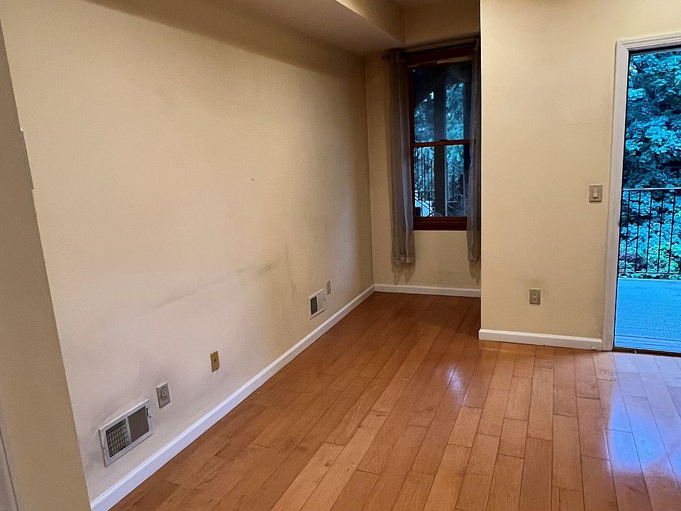 Spacious living area with beautiful hardwood flooring throughout the space