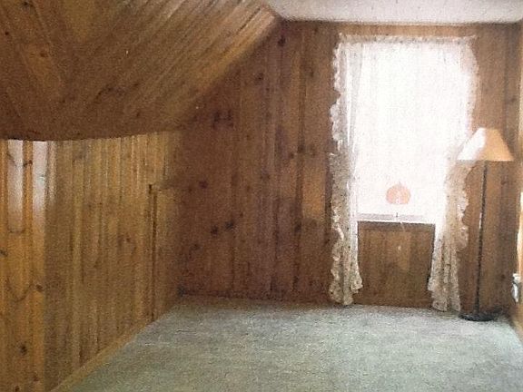 Carpeted upstairs bedroom measures 22 & 1/2' x 12' x 8' with
